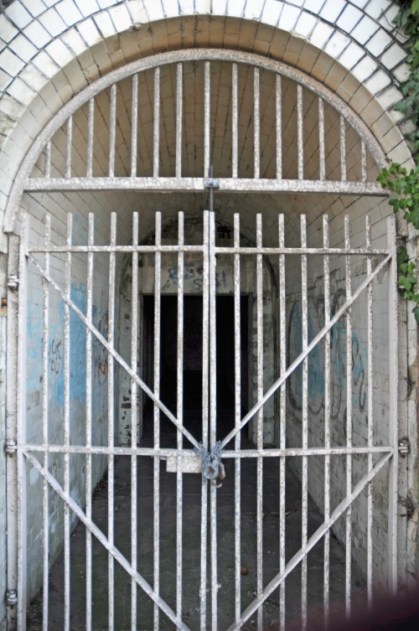 Iron gate closing off a tunnel under the railway line